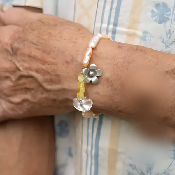 Dawn Blossom, handmade pearl, citrine and clear quartz bracelet worn on the hand
