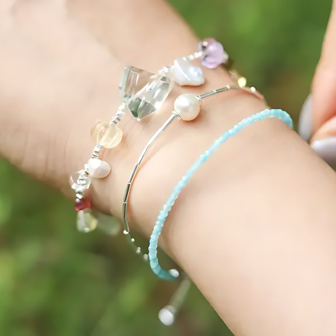 Island Heart, handmade clear quartz, amethyst and pearl bracelet worn on the hand