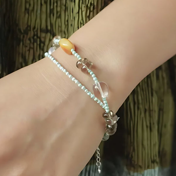 Moon Between Pines, handmade turquoise, smoky quartz and clear quartz bracelet worn on the hand