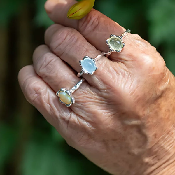 Morning Petals, handmade blue chalcedony, prehnite and moonstone ring worn on the hand