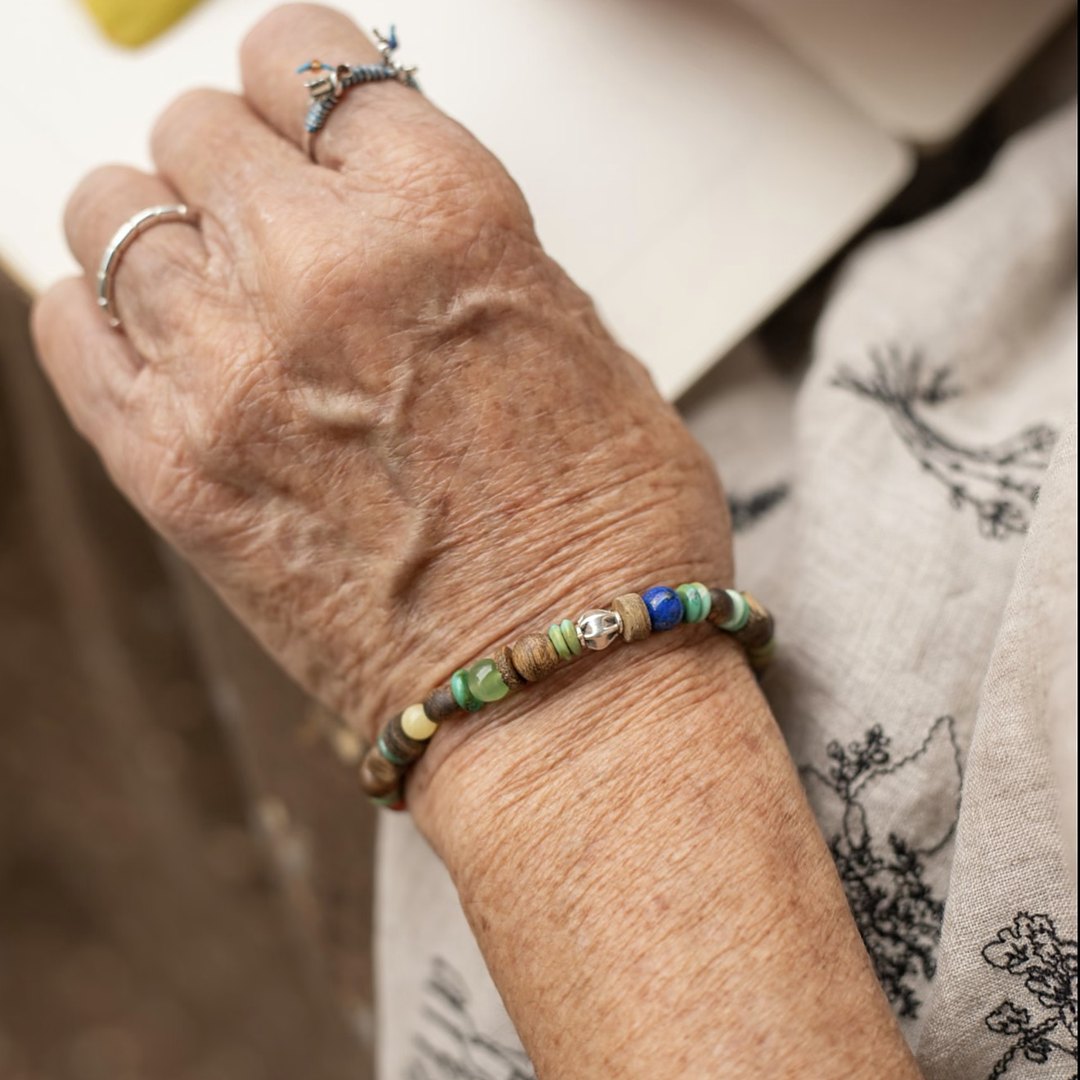 Painted Autumn, handmade agarwood, turquoise and lapis lazuli bracelet worn on the hand