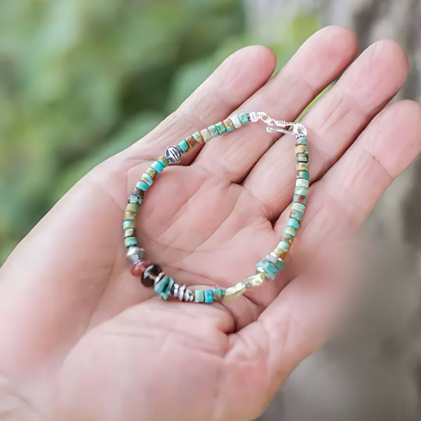 Sky to Moss, handmade turquoise and garnet bracelet worn on the hand
