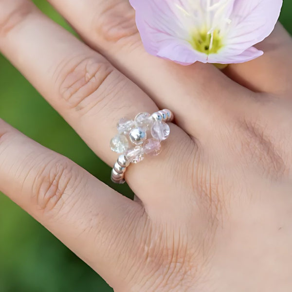 Sugar Blossom, handmade clear quartz and rose quartz ring worn on the hand