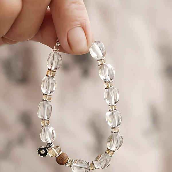 Unturned Pages, handmade clear quartz, smoky quartz and agarwood & sandalwood bracelet worn on the hand