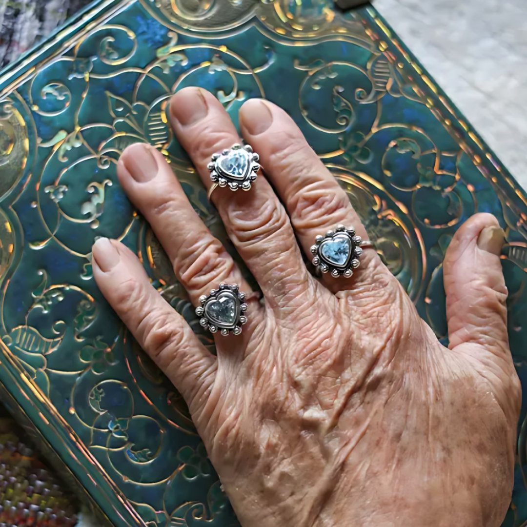 Witch's Blue Heart, handmade blue topaz ring worn on the hand