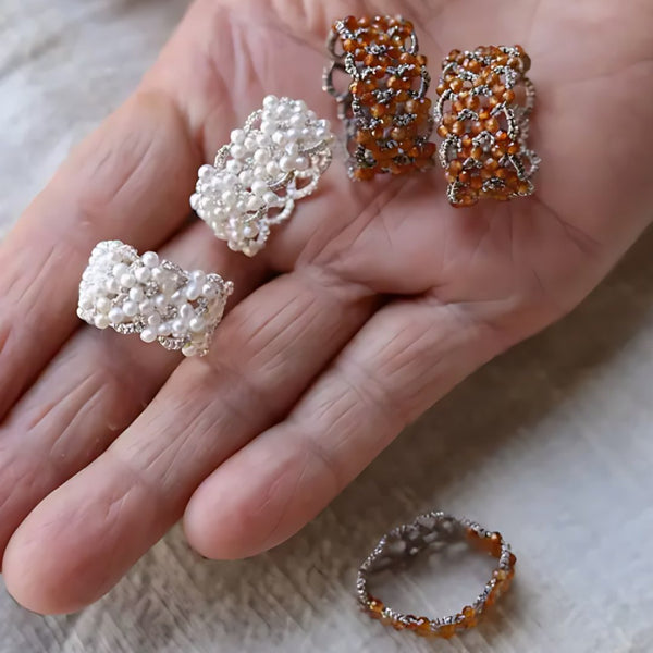 Woven Hours, handmade pearl and garnet ring worn on the hand