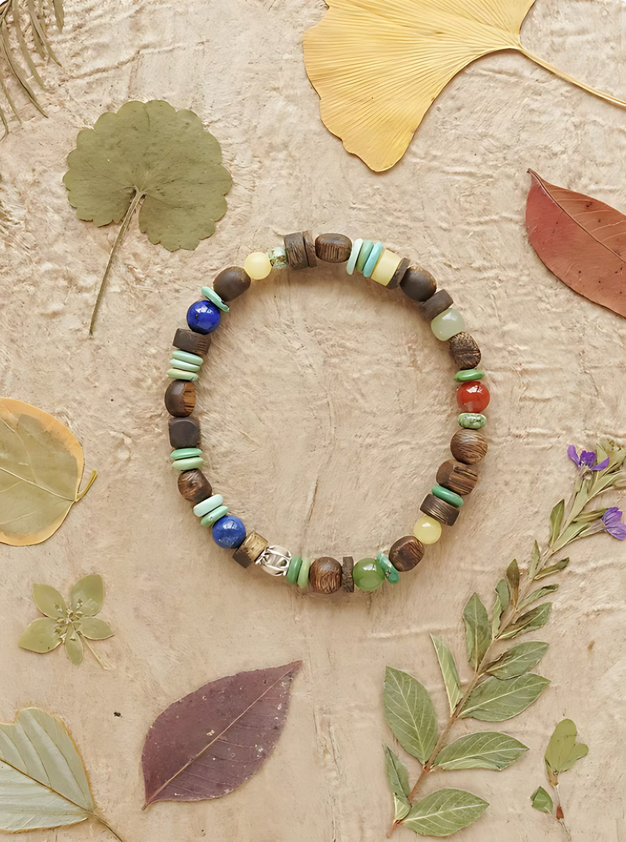 Agarwood, turquoise and lapis bracelet among pressed autumn leaves