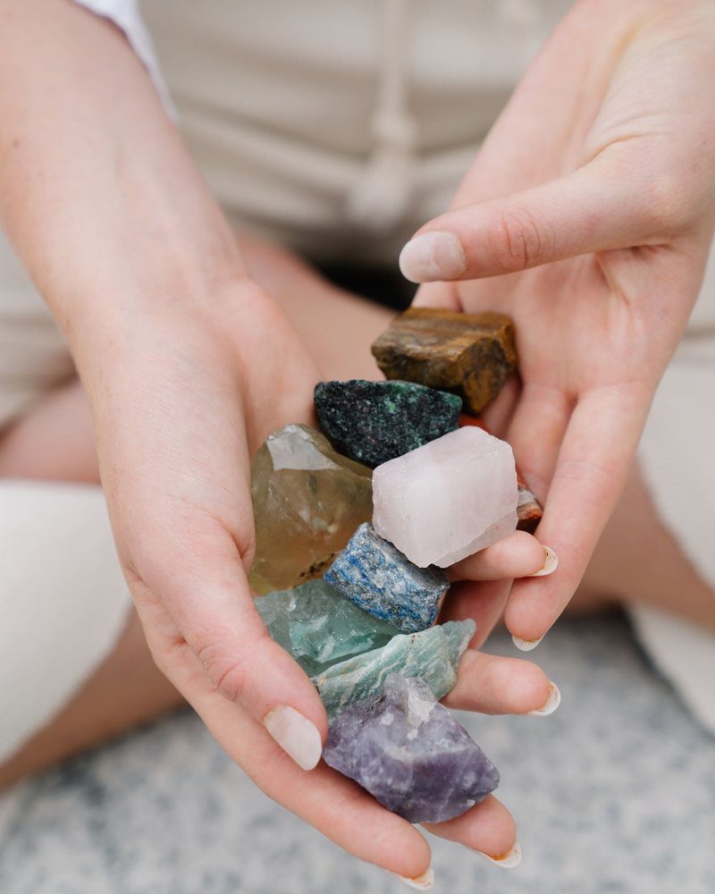 Hands holding a few rough natural stones