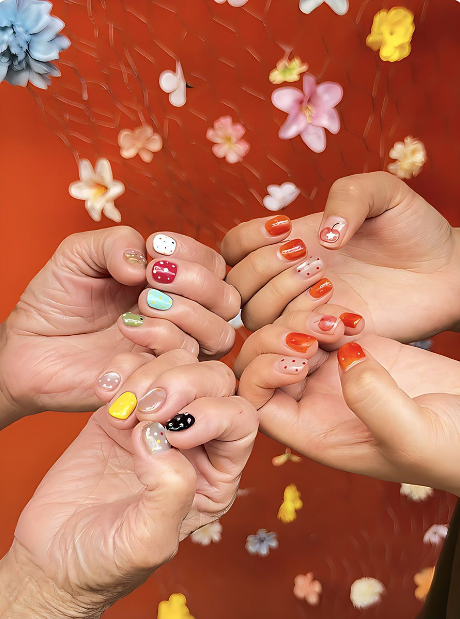 Grandma and a granddaughter showing painted nails against a red flowered background