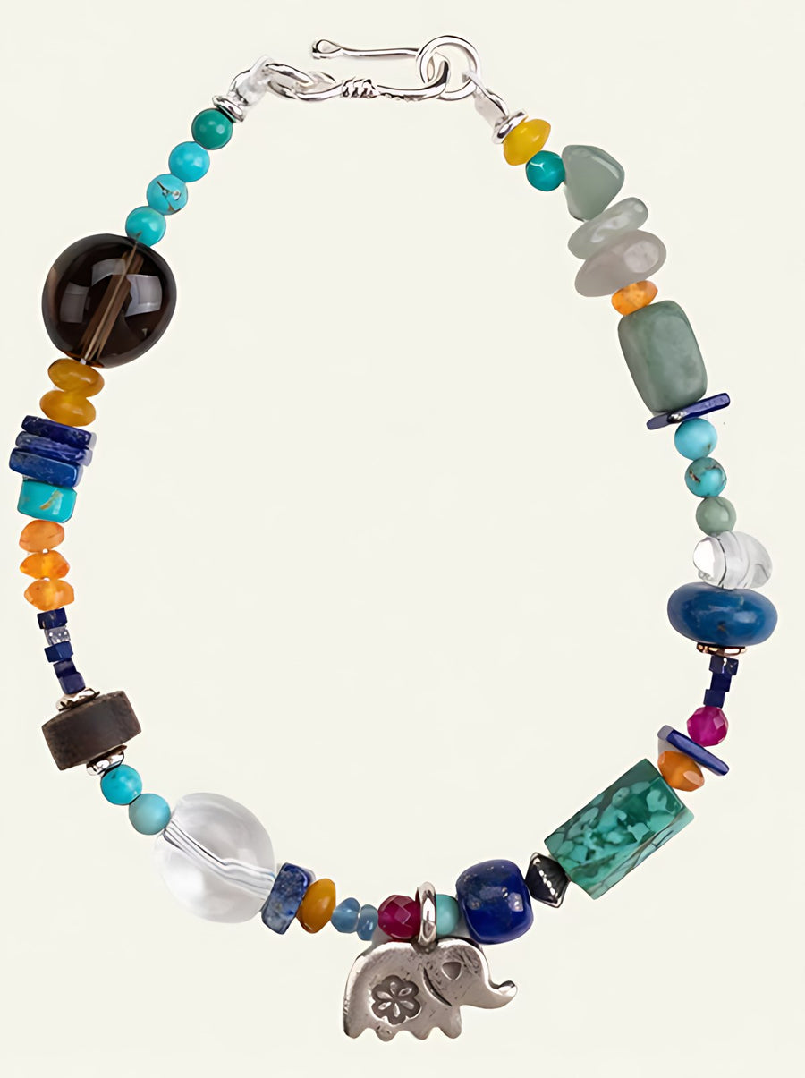 The Star-Keeper Elephant bracelet laid flat: turquoise, tiger's eye, lapis and a silver elephant